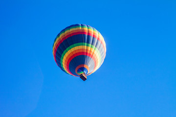 Colorful hot air balloons over blue sky.