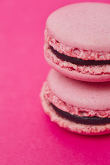 Two macarons on magenta background