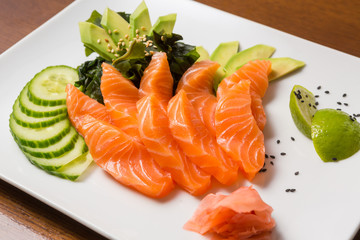 Raw salmon avocado cucumber served on a plate
