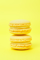 Two macarons on yellow background