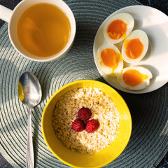 Healthy cereal oat with boiled eggs at breakfast. Top view
