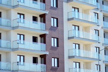Modern apartment buildings on a sunny day with a blue sky. Facade of a modern apartment building