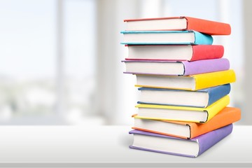 Colorful books collection on background.