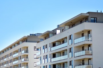 Fototapeta premium Modern apartment buildings on a sunny day with a blue sky. Facade of a modern apartment building