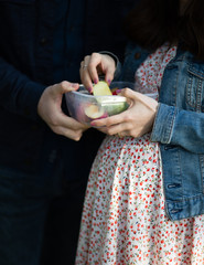 Pregnant woman and husband eating fruits. Healthy life