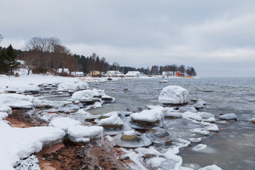 Ice-covered rocks on the shore of the Baltic Sea. Kasmu village, Estonia, winter daytime.