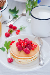 Homemade Pancakes with fresh red berries and honey