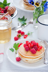 Homemade Pancakes with fresh red berries and honey