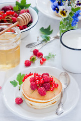 Homemade Pancakes with fresh red berries and honey