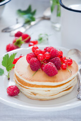 Homemade Pancakes with fresh red berries and honey