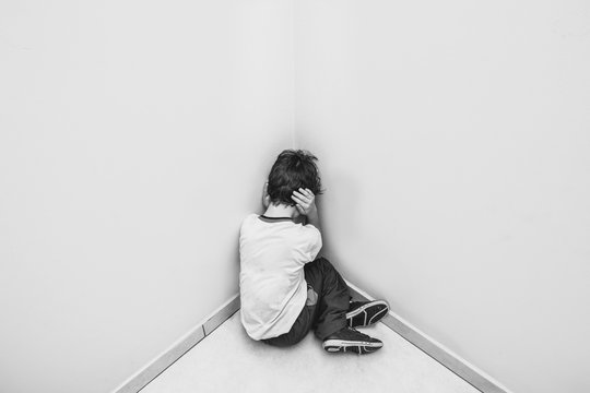 Child In School Uniform Crying And Hiding His Face.