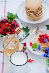 Homemade Pancakes with fresh red berries and honey