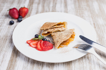 Two marmalade pancake with strawberries