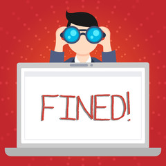 Text sign showing Fined. Business photo showcasing clarify beer by causing precipitation of sediment during production Man Holding and Looking into Binocular Behind Open Blank Space Laptop Screen