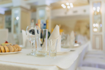 dishes on banquet tables, serving glasses, spoons and plates