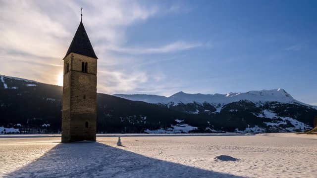 Timelapse of sunset over lake Reschen in winter