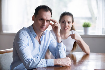 Depressed man turn back ignoring angry screaming woman