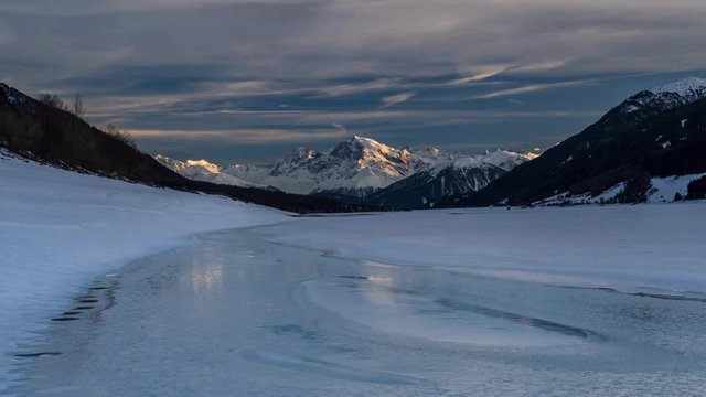 Timelapse of sunset over lake Reschen in winter