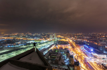 man on the edge of the roof of the night city