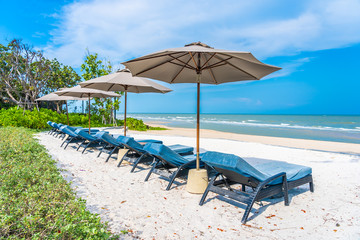 Umbrella and chair on the beach sea ocean with blue sky and white cloud