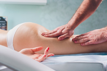 anti-cellulite massage on the legs of young women.