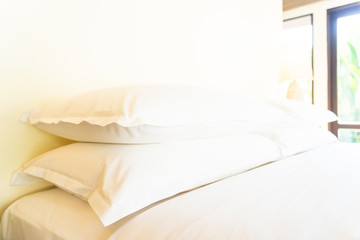 Fototapeta na wymiar Beautiful comfortable pillow on bed decoration in bedroom