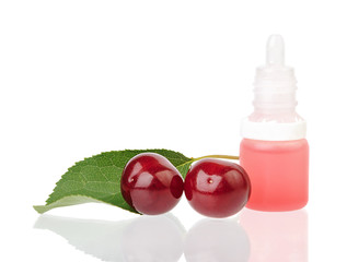 Bottle with liquid for smoking with cherry flavor and two cherries isolated on white background