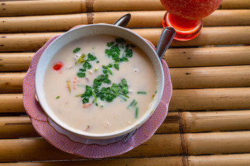 Thai Dishes - Tom Yam Kung. Spicy Shrimp Soup with Coconut milk, Lime and Seafood