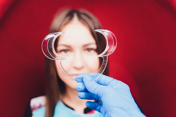 Close up of female mouth with retractor. Doctor flossing the teeth. Dental Gag.