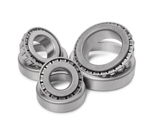 Three automotive roller bearings isolated on white background.
