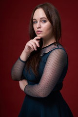 Portrait of a female in a colored dress on red background