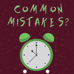 Conceptual hand writing showing Common Mistakes question. Concept meaning repeat act or judgement misguided or wrong Colorful Round Analog Two Bell Alarm Desk Clock Hand photo