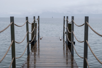 pier in the rain at a lake in Switzerland