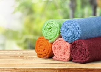 Obraz na płótnie Canvas Laundry Basket with colorful towels on background