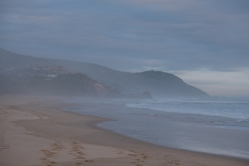 Fototapeta na wymiar The sandy beach at Brenton on Sea, photographed at dusk. Knysna, South Africa.