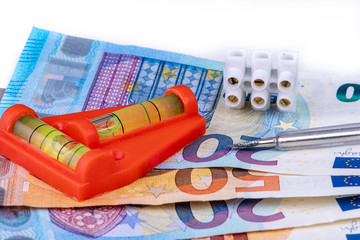 illegal work with spirit level and screwdriver and many Euro banknotes
