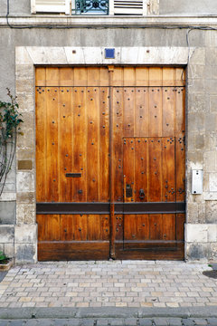 solid old wooden door of a house of Orleans, large and old French on the banks of the Loire, in Loiret, Centre-Val-de-Loire region