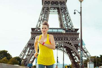 sports woman not far from Eiffel tower in Paris, France jogging