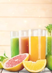 Tasty fruits  and juice with vitamins on background