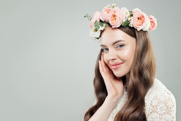 Smiling Woman with Curly Hair, Natural Makeup and Flowers Portrait