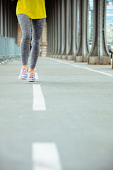 Fototapeta premium Closeup on woman on Pont de Bir-Hakeim bridge in Paris jogging