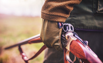 Hunter with a rifle in hunting