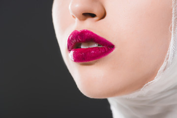cropped view of young woman with crimson lips isolated on grey