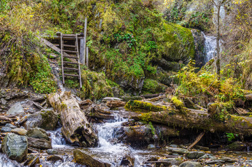 Old wooden staircase for descent to the mountain river
