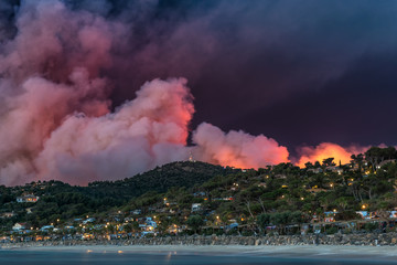 thick smoke is spreading over the hill during forest fire