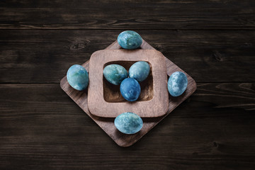 Aquamarine easter eggs on a wooden background