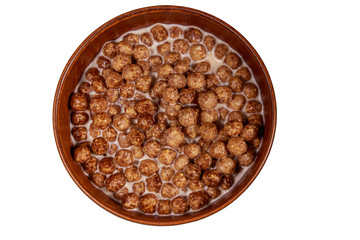 Cereal chocolate balls with milk in a bowl isolated on white background