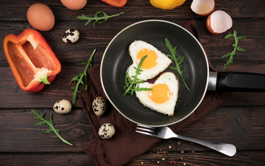 fried eggs in the form of a heart in a skillet