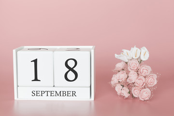 September 18th. Day 18 of month. Calendar cube on modern pink background, concept of bussines and an importent event.