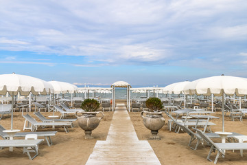 Empty beach with white sunshades against the sky, Italy, Riccione